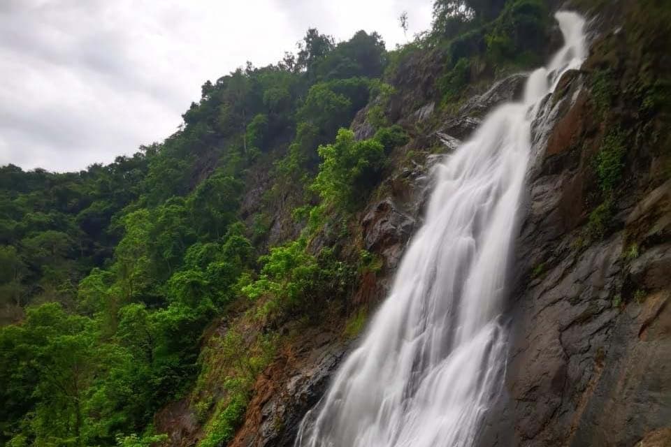 Bijagual falls dropping down a long rock face, forest either side.