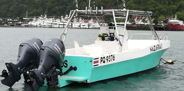 Nazaria II at the dock, a turquoise-hulled centre console on twin Yamaha outboards.
