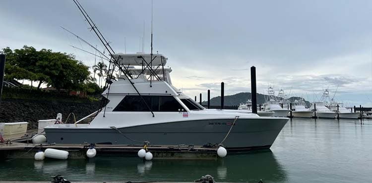 Sueltalo 2 tied up at the dock at first light, other sport fishers along the pier behind.