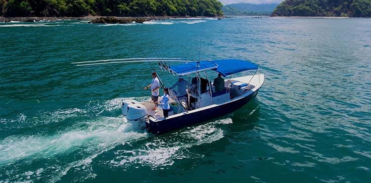 Take It Easy under way, a 27-foot centre console with four aboard and the rods up.