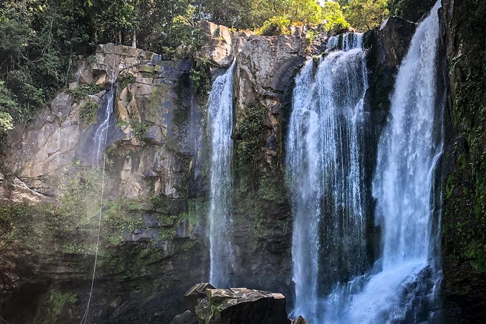 The upper falls close up: two white columns dropping down a dark rock wall.